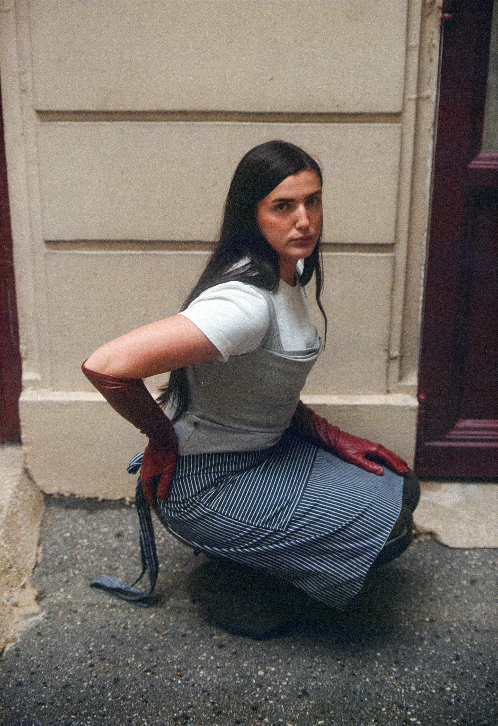 girl wearing a blue and white striped cotton apron.