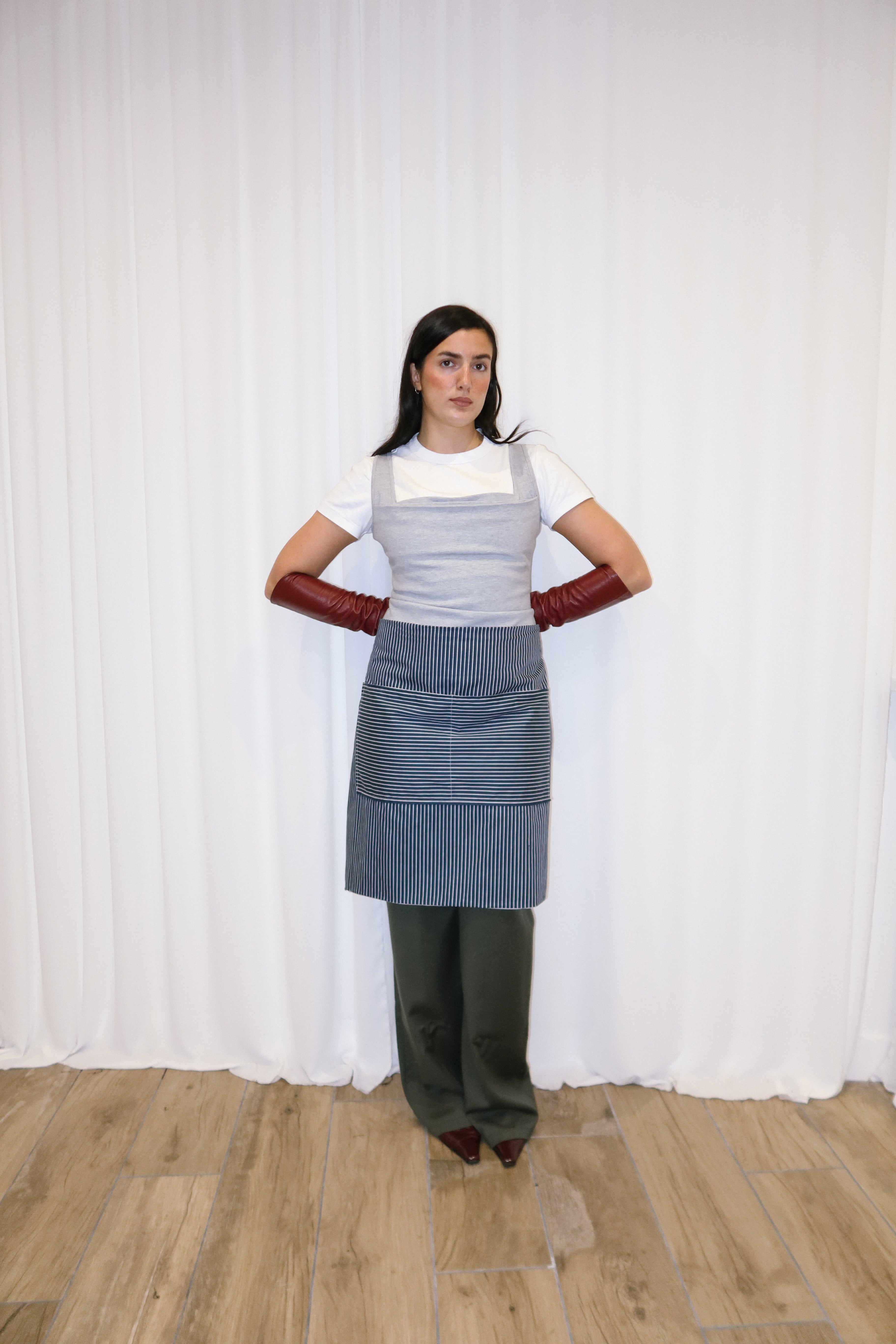 girl wearing a blue and white striped cotton apron.